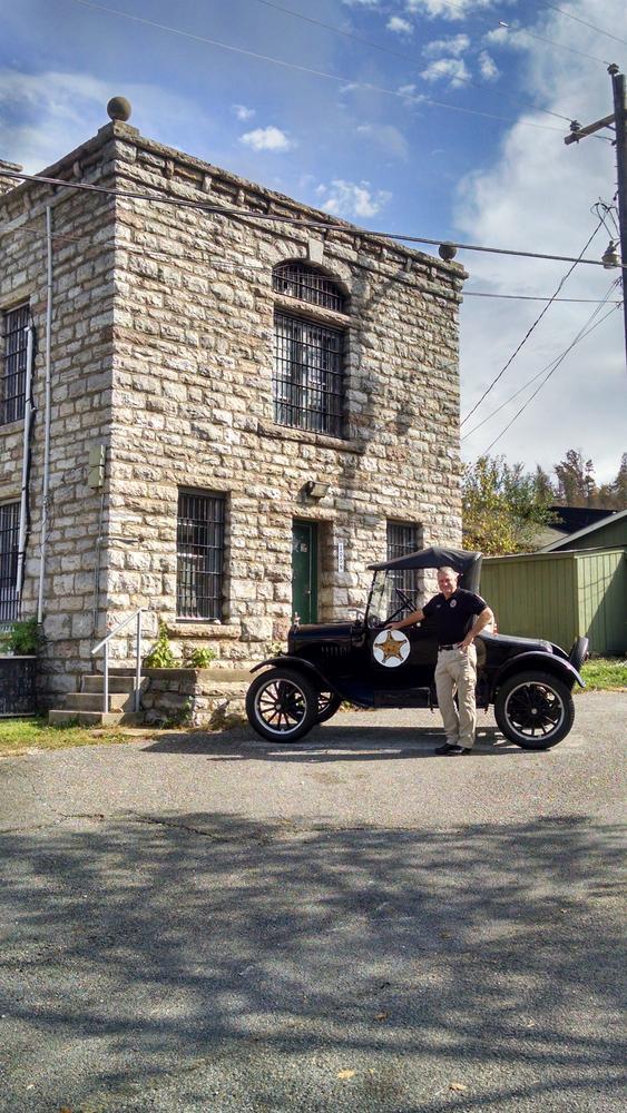 Keith and old car in front of original jail
